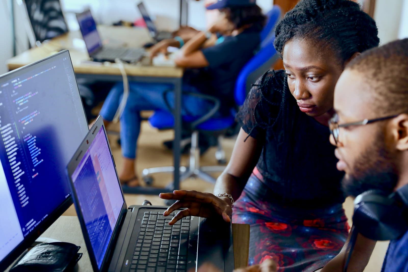 Two colleagues in Lagos reviewing a laptop screen together