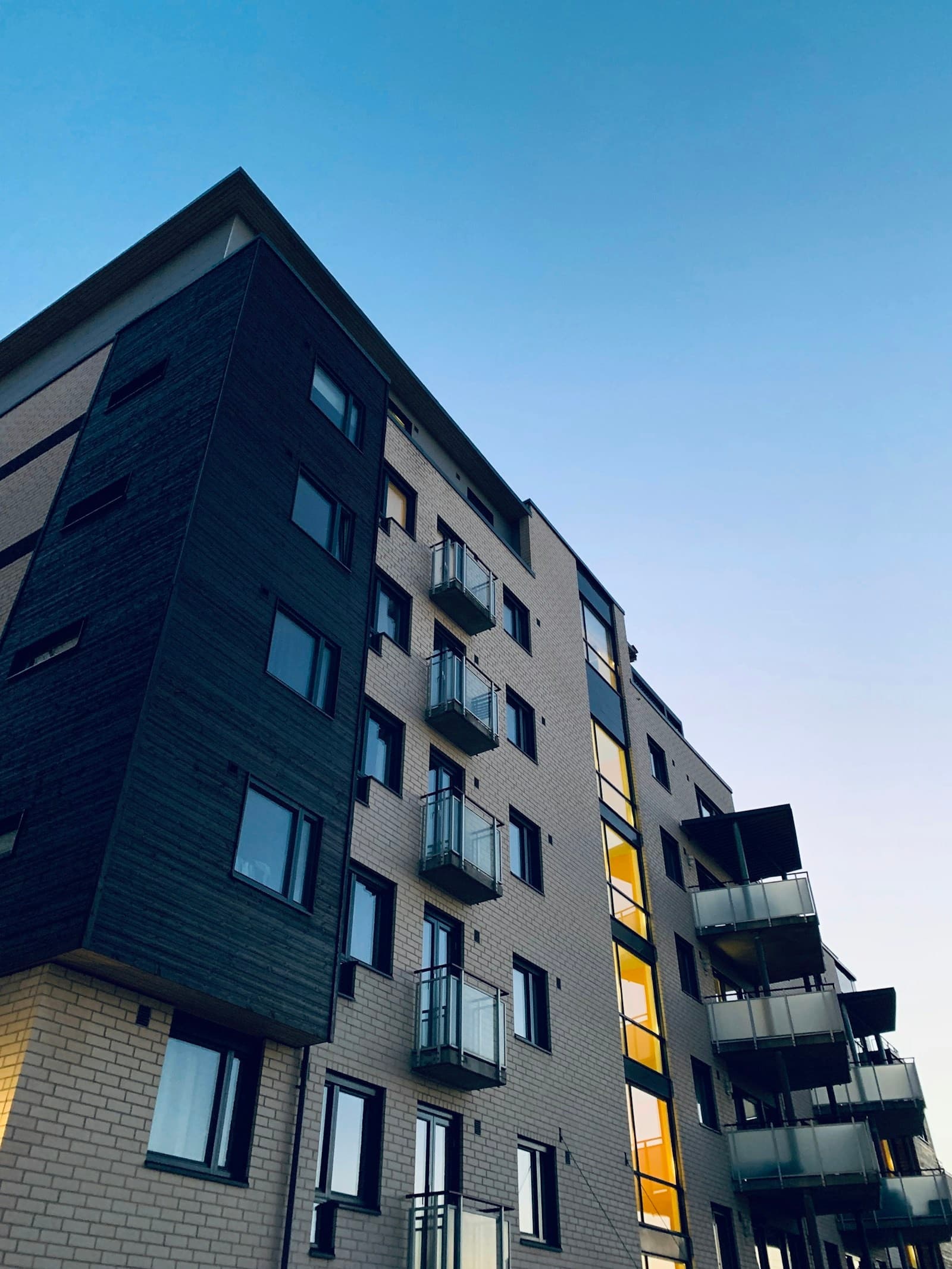 A modern apartment building against a clear sky